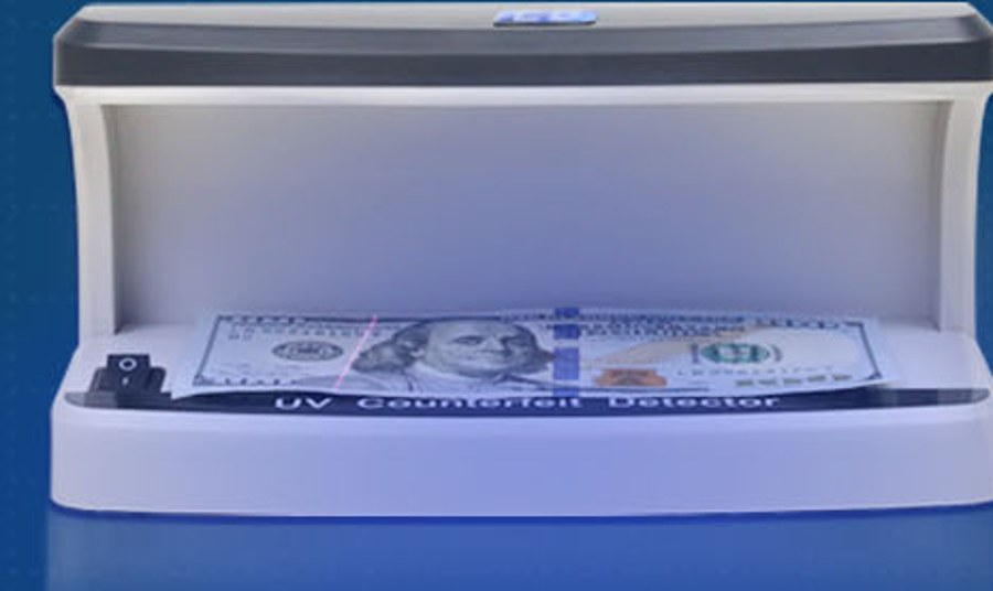 UV banknote detector showing the security thread under 365nm light